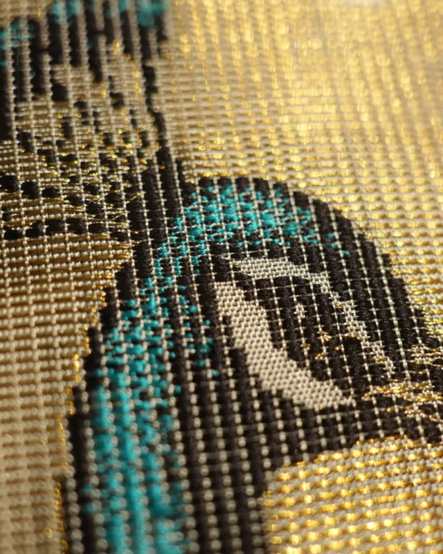 Peacock head woven in turquoise and black silk on a gold zari ground